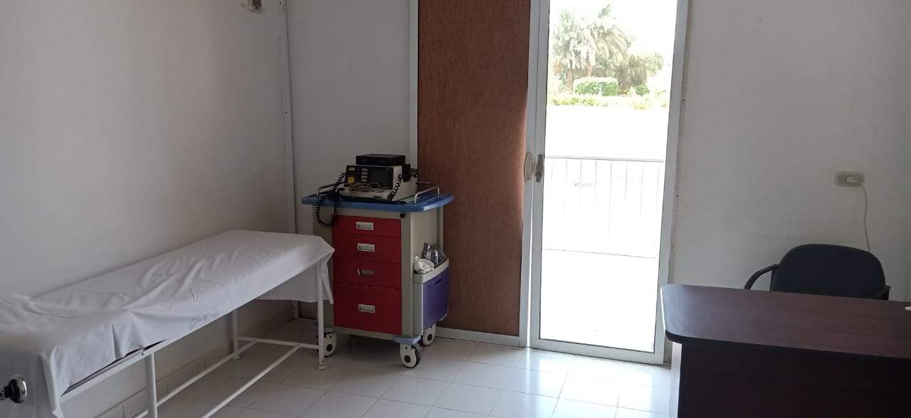 Unoccupied examination room with a consultation desk at Jasmine Hospital in Hurghada